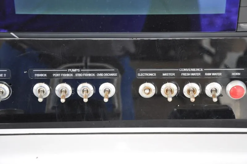 Slide: The Image of Control panel of a 2017 Sportsman Open 282 Center Console boat with labeled switches. - 25