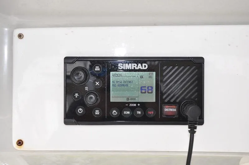 Slide: The Image of Simrad marine radio on 2017 Sportsman Open 282 Center Console boat dashboard. - 28