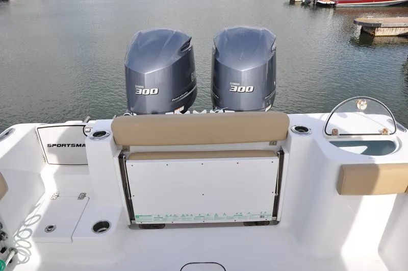 Slide: The Image of 2017 Sportsman Open 282 Center Console with twin 300 engines, docked on calm water. - 3