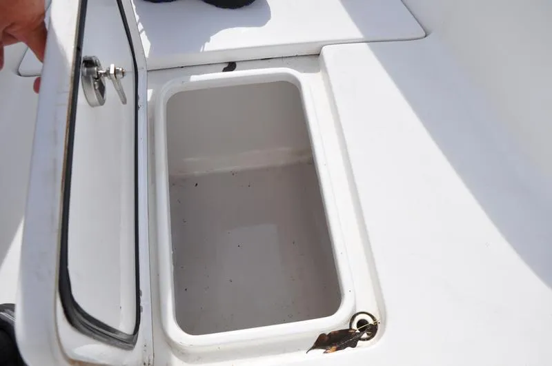 Slide: The Image of Open storage compartment on 2017 Sportsman Open 282 Center Console boat. - 37