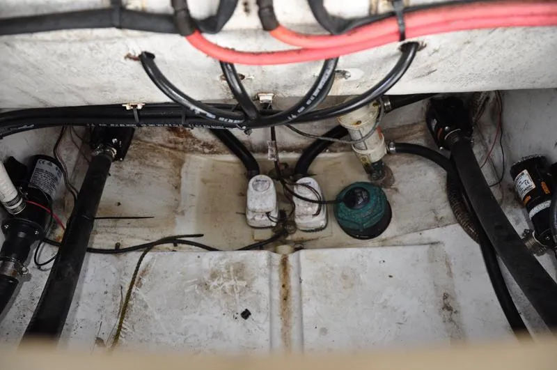 Slide: The Image of Bilge area of 2017 Sportsman Open 282 Center Console boat with wiring and pumps. - 8