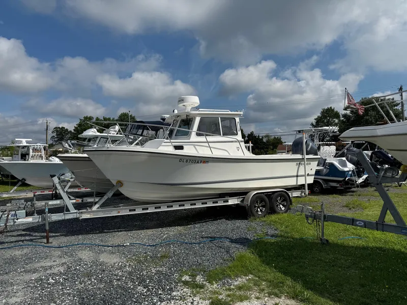 The Image of 2024 Steiger Craft 23 Miami boat on trailer under cloudy sky. - 0