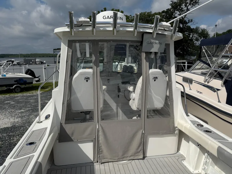 Slide: The Image of 2024 Steiger Craft 23 Miami boat with Garmin equipment, docked under cloudy skies. - 10