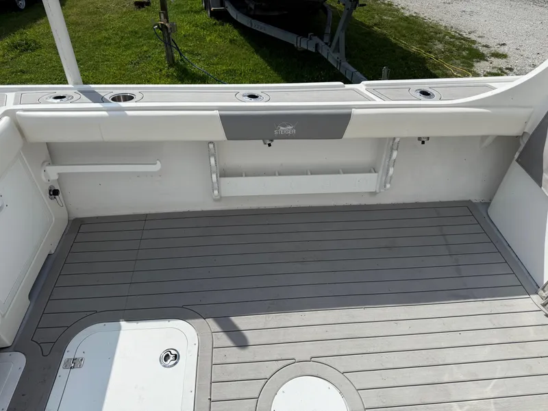 Slide: The Image of 2024 Steiger Craft 23 Miami boat deck with rod holders and storage compartments. - 12
