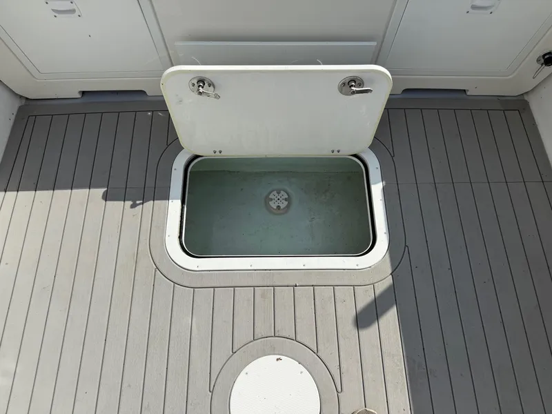 Slide: The Image of 2024 Steiger Craft 23 Miami boat deck with open storage compartment. - 13