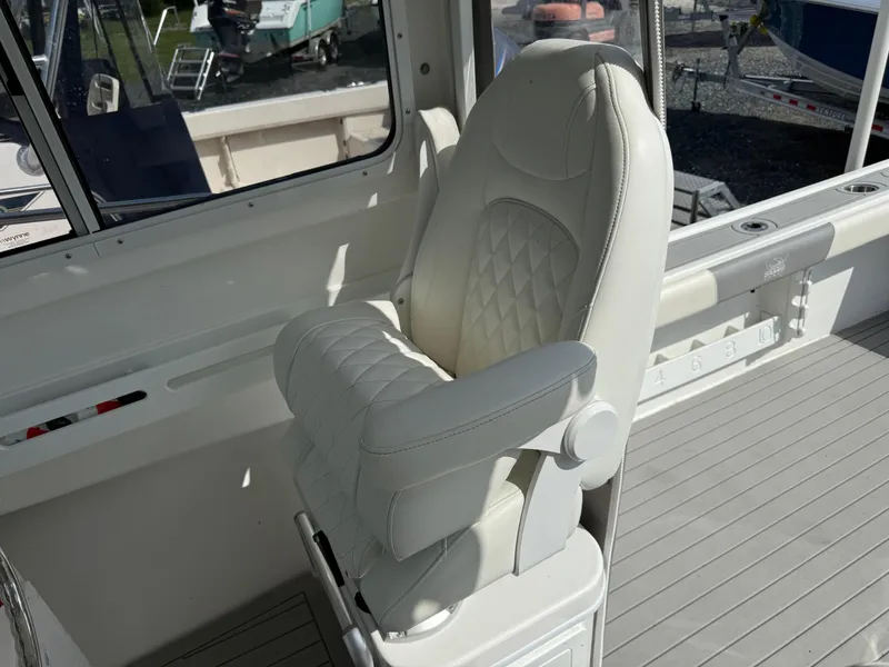 Slide: The Image of Luxury seating on 2024 Steiger Craft 23 Miami boat, featuring white quilted upholstery. - 16