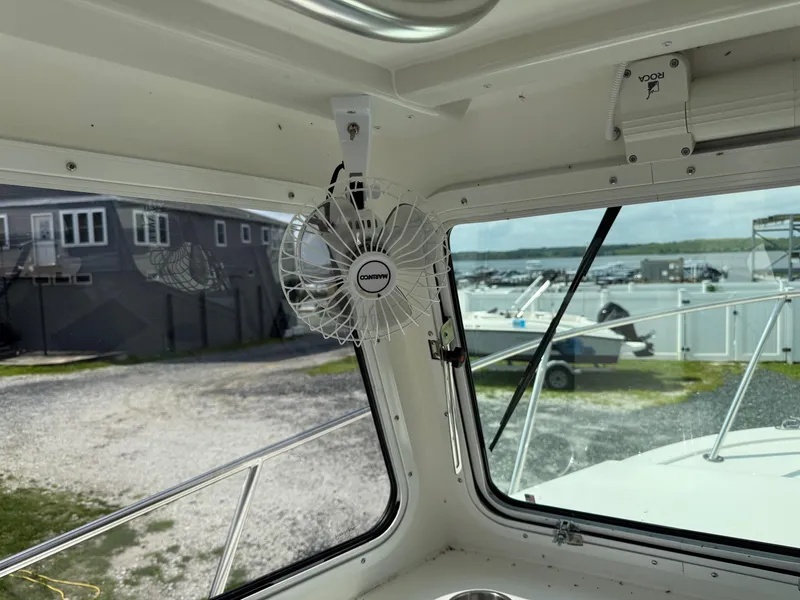 Slide: The Image of 2024 Steiger Craft 23 Miami boat interior with fan and marina view. - 19