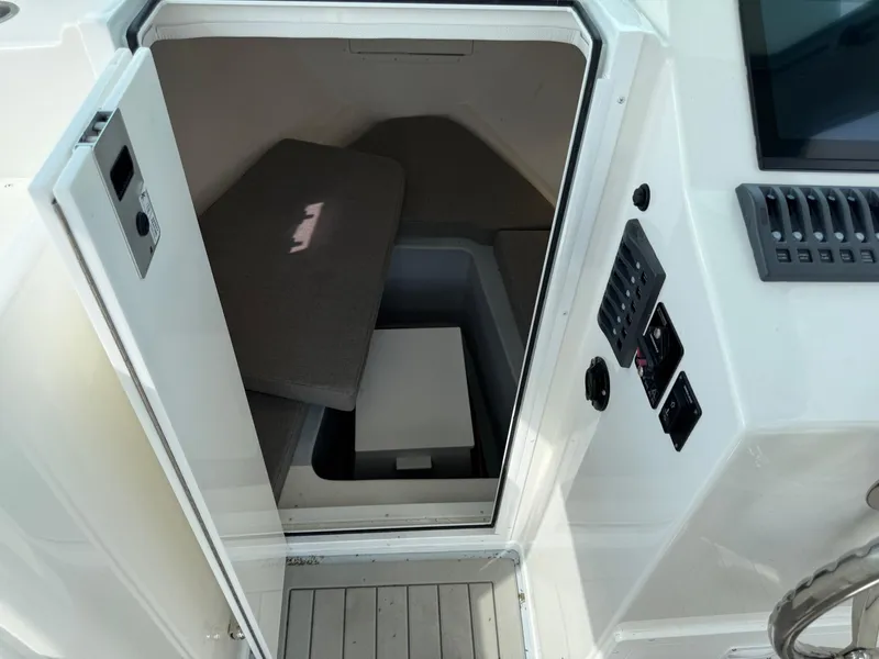 Slide: The Image of 2024 Steiger Craft 23 Miami cabin interior with seating and control panel. - 20