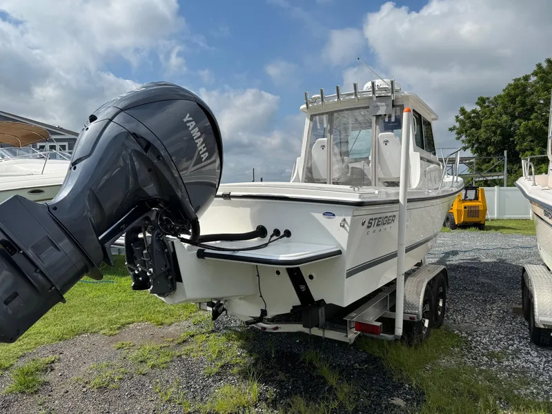 Slide: The Image of 2024 Steiger Craft 23 Miami boat with Yamaha engine on trailer, parked outdoors. - 5