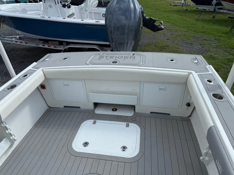 Slide: The Image of 2024 Steiger Craft 23 Miami boat deck with storage compartments and motor. - 8