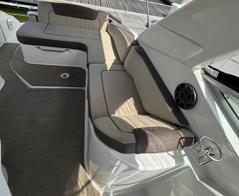 Slide: The Image of 2014 Sea Ray 280 Sundancer interior seating with beige upholstery and speaker. - 11