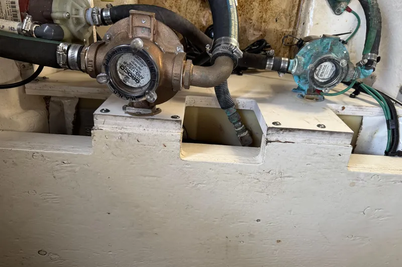 Slide: The Image of Engine compartment of a 2014 Sea Ray 280 Sundancer with visible mechanical components. - 26