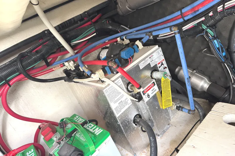 Slide: The Image of Engine compartment of a 2014 Sea Ray 280 Sundancer with wiring and battery connections. - 28