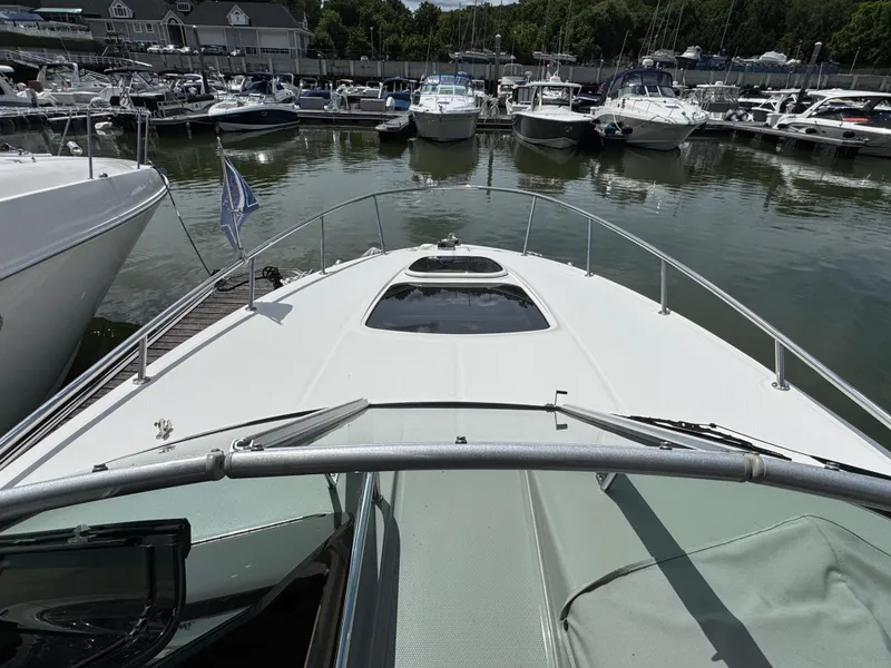 Slide: The Image of 2014 Sea Ray 280 Sundancer docked at marina with other boats. - 7