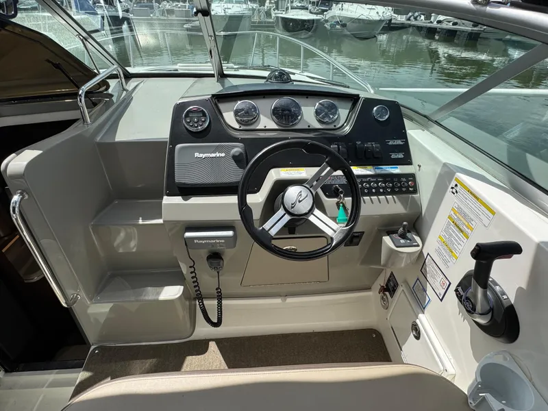 Slide: The Image of Cockpit of 2014 Sea Ray 280 Sundancer with steering wheel and control panel. - 8