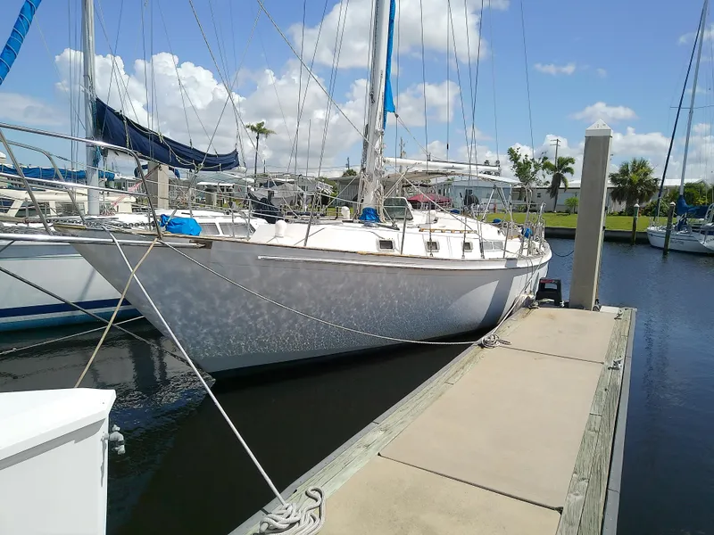 The Image of 1980 Whitby Yachts 42 sailboat docked in a sunny marina. - 0