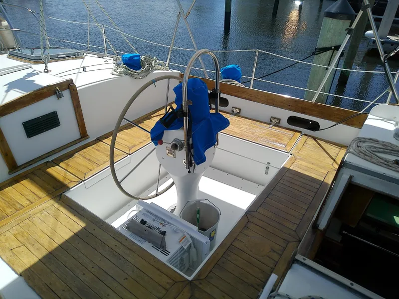 Slide: The Image of 1980 Whitby Yachts 42 sailboat deck view at marina, featuring rigging and equipment. - 10