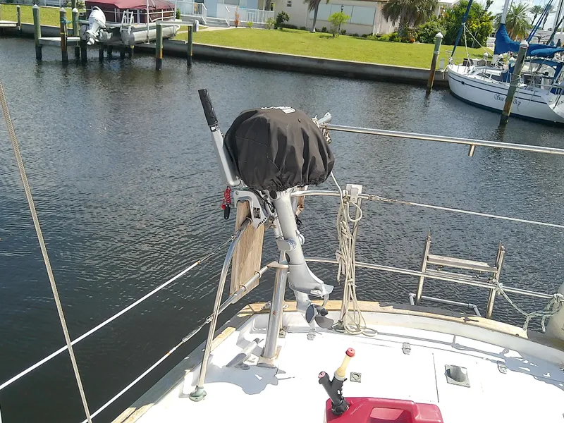Slide: The Image of Whitby Yachts 42 sailboat docked in marina, 1980 model, with other boats and palm trees nearby. - 12