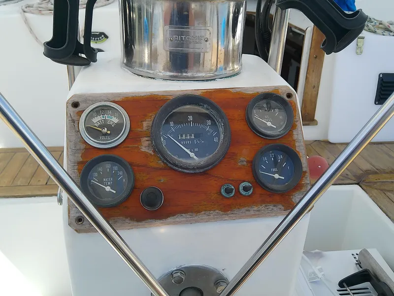 Slide: The Image of Compass on 1980 Whitby Yachts 42 sailboat, reflecting deck and rigging details. - 14