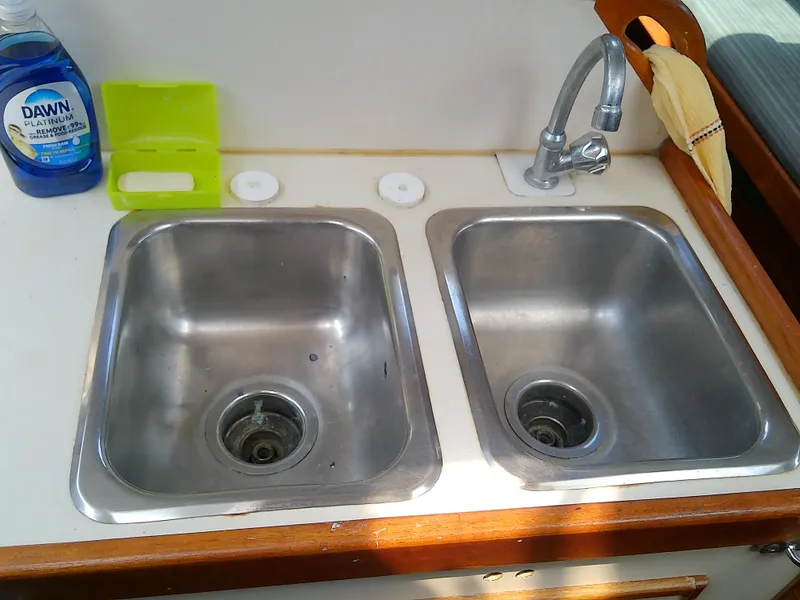Slide: The Image of Galley sink area in 1980 Whitby Yachts 42, featuring dual stainless steel basins. - 33