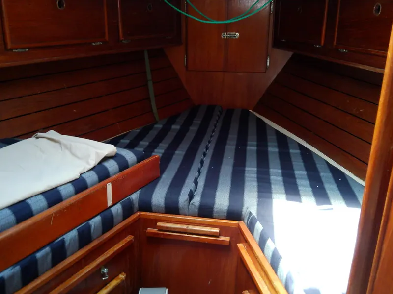 Slide: The Image of Interior of 1980 Whitby Yachts 42, featuring cozy seating and wooden accents. - 35