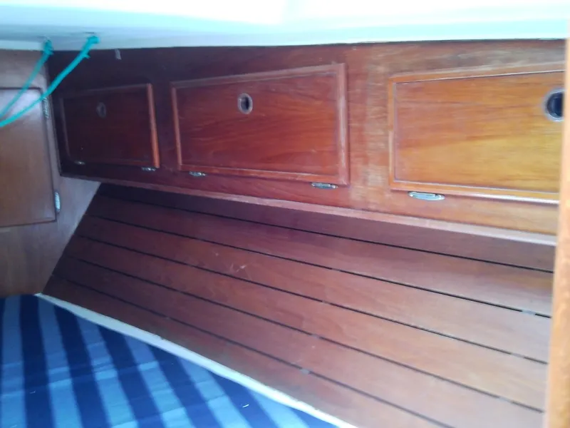 Slide: The Image of Interior of 1980 Whitby Yachts 42, featuring cozy seating and wooden accents. - 37