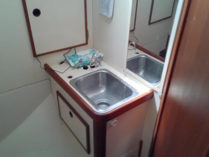 Slide: The Image of Cozy cabin interior of 1980 Whitby Yachts 42 with striped bedding and floral pillows. - 38