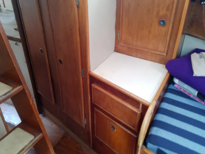 Slide: The Image of Interior of 1980 Whitby Yachts 42, featuring wooden ladder and cabinetry. - 45