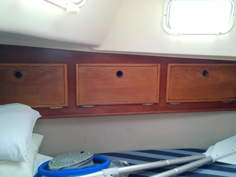 Slide: The Image of 1980 Whitby Yachts 42 interior with wooden cabinetry and white countertops. - 46