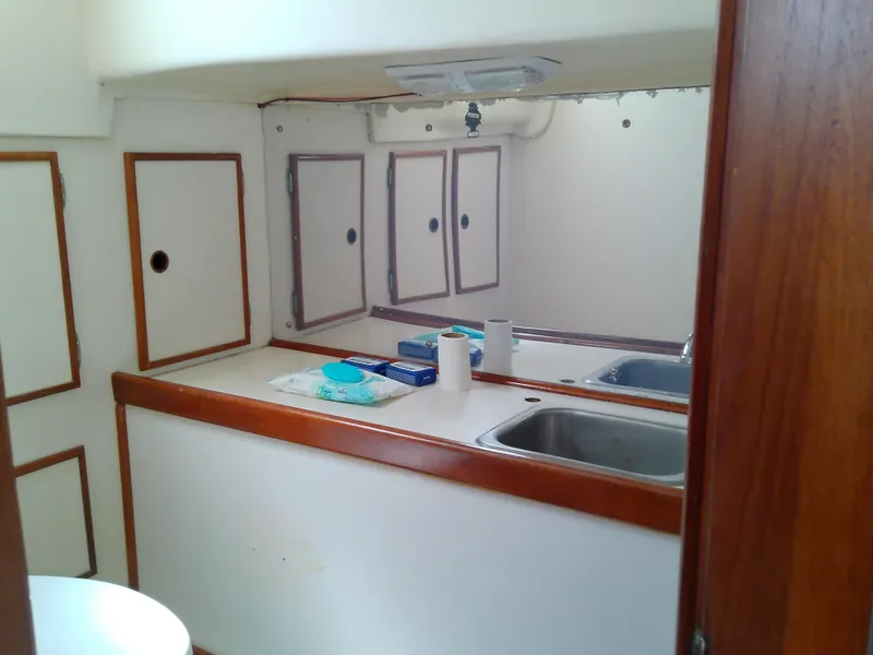 Slide: The Image of 1980 Whitby Yachts 42 interior with wooden table and seating area. - 48