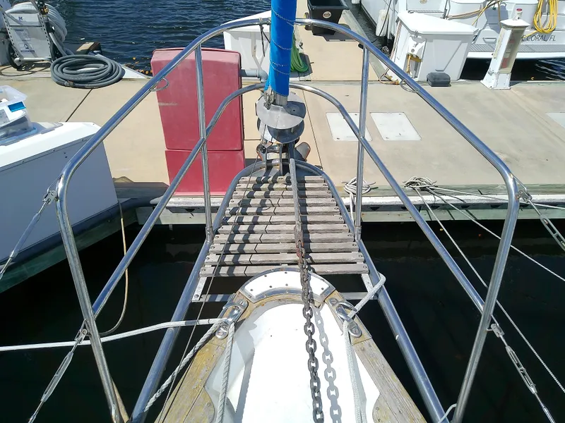 Slide: The Image of 1980 Whitby Yachts 42 sailboat with solar panel, docked in a marina under a sunny sky. - 7