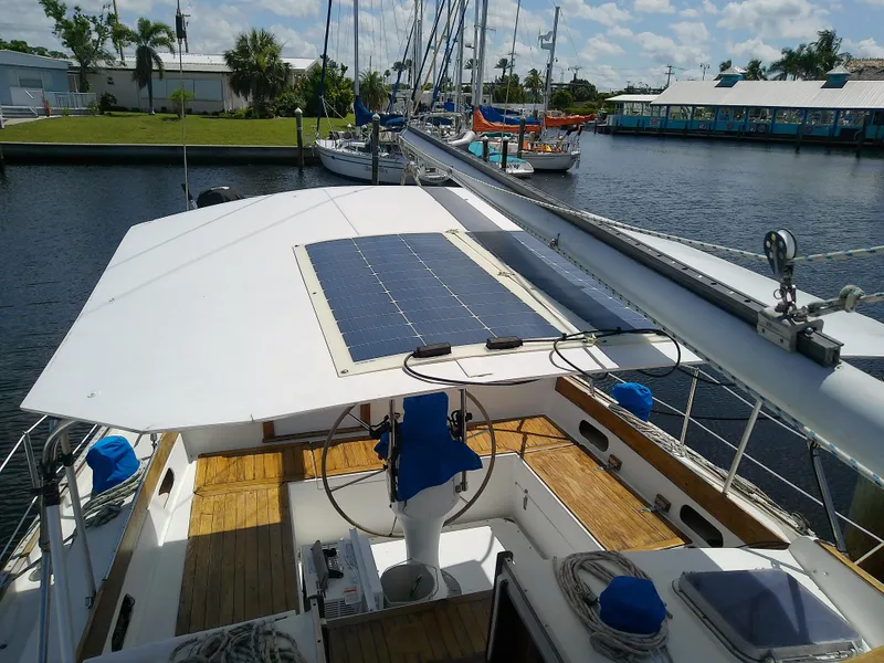 Slide: The Image of 1980 Whitby Yachts 42 sailboat cockpit with wooden deck and steering wheel. - 8