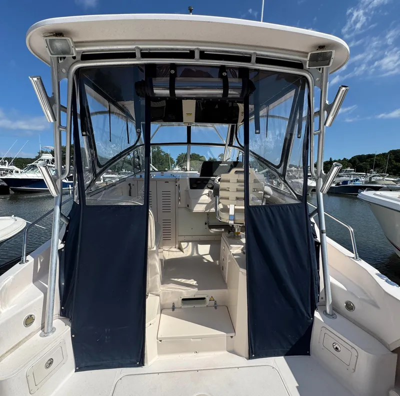 Slide: The Image of 2003 Grady-White Marlin 300 boat interior with blue canvas, docked in marina. - 10