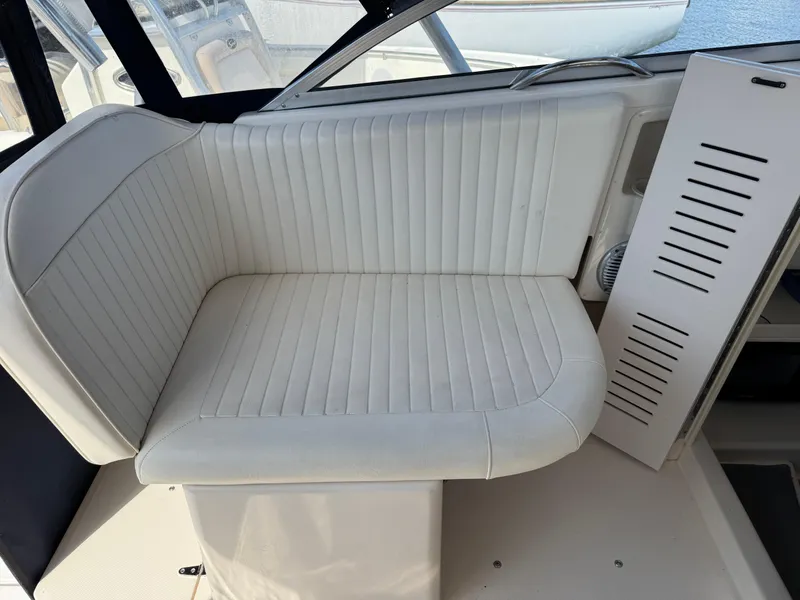Slide: The Image of 2003 Grady-White Marlin 300 boat interior with white cushioned seating. - 15