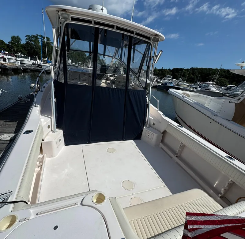 Slide: The Image of 2003 Grady-White Marlin 300 boat docked at marina under clear blue sky. - 16