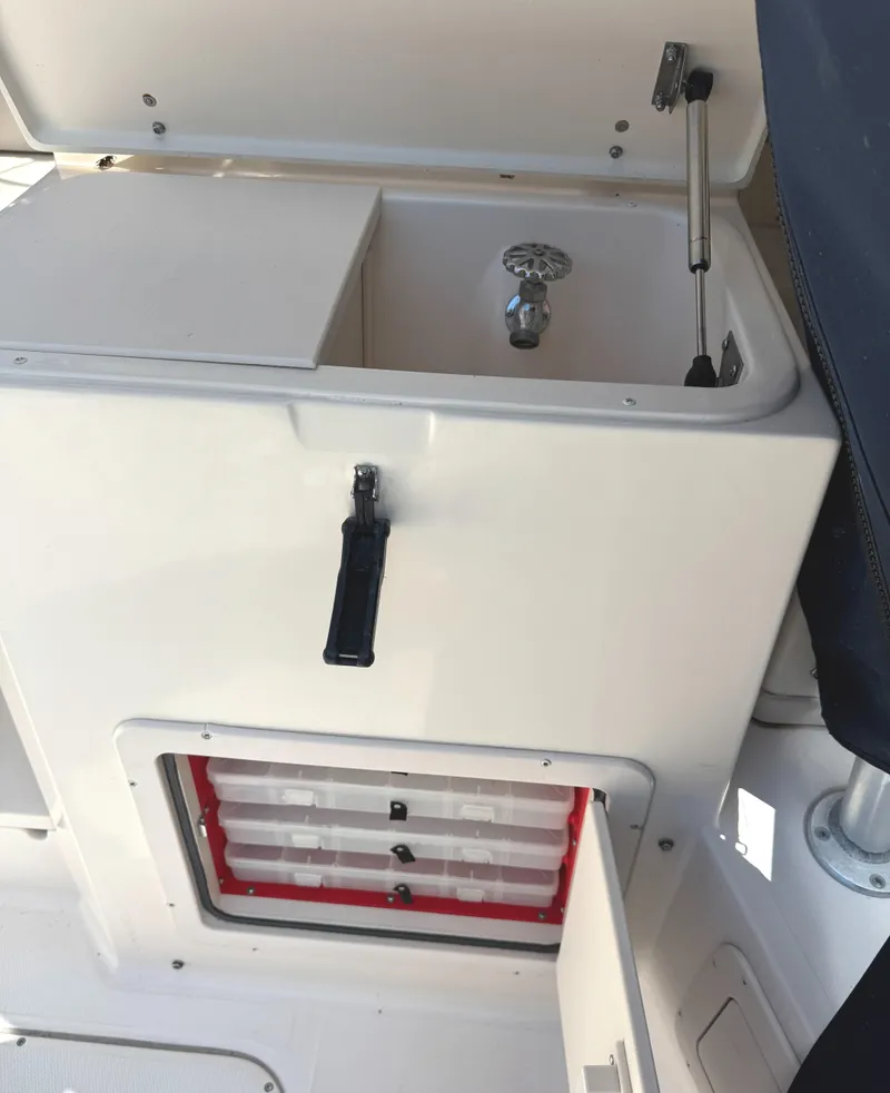 Slide: The Image of 2003 Grady-White Marlin 300 boat sink and storage compartment. - 17