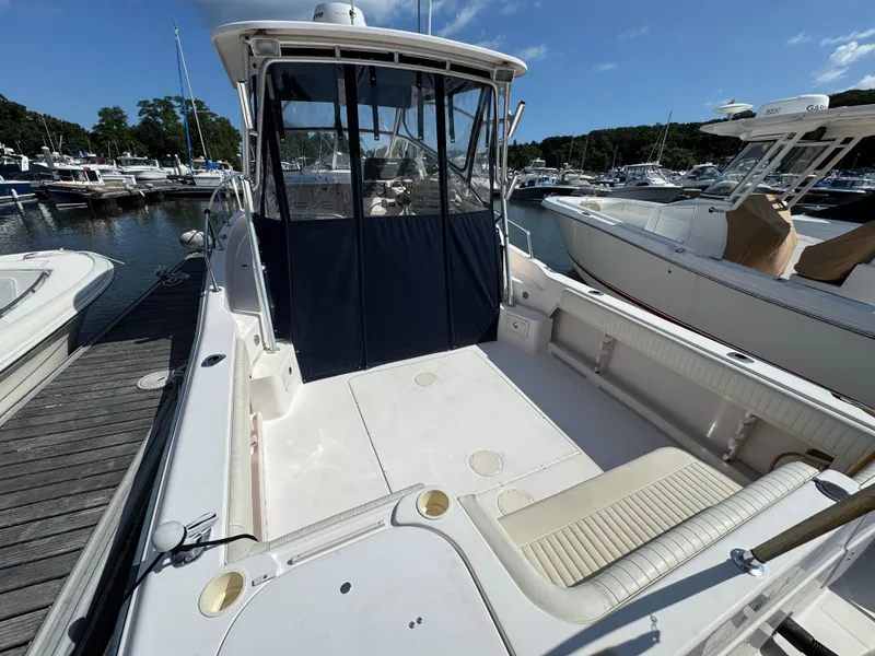 Slide: The Image of 2003 Grady-White Marlin 300 boat docked at a marina under clear blue skies. - 2