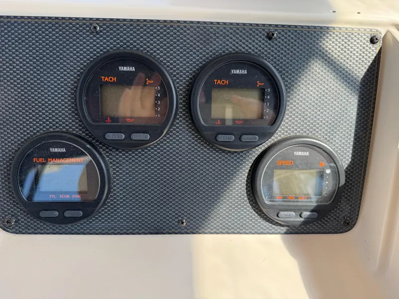 Slide: The Image of Yamaha gauges on 2003 Grady-White Marlin 300 boat dashboard, featuring tachometer and fuel management. - 20