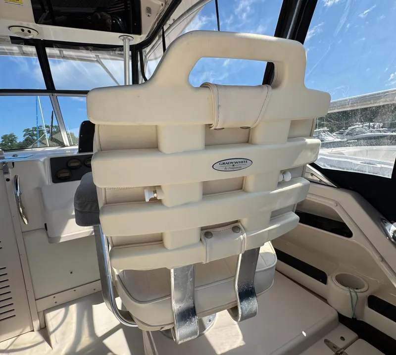 Slide: The Image of Grady-White Marlin 300 boat seat, 2003 model, with white cushioning and metal supports. - 21