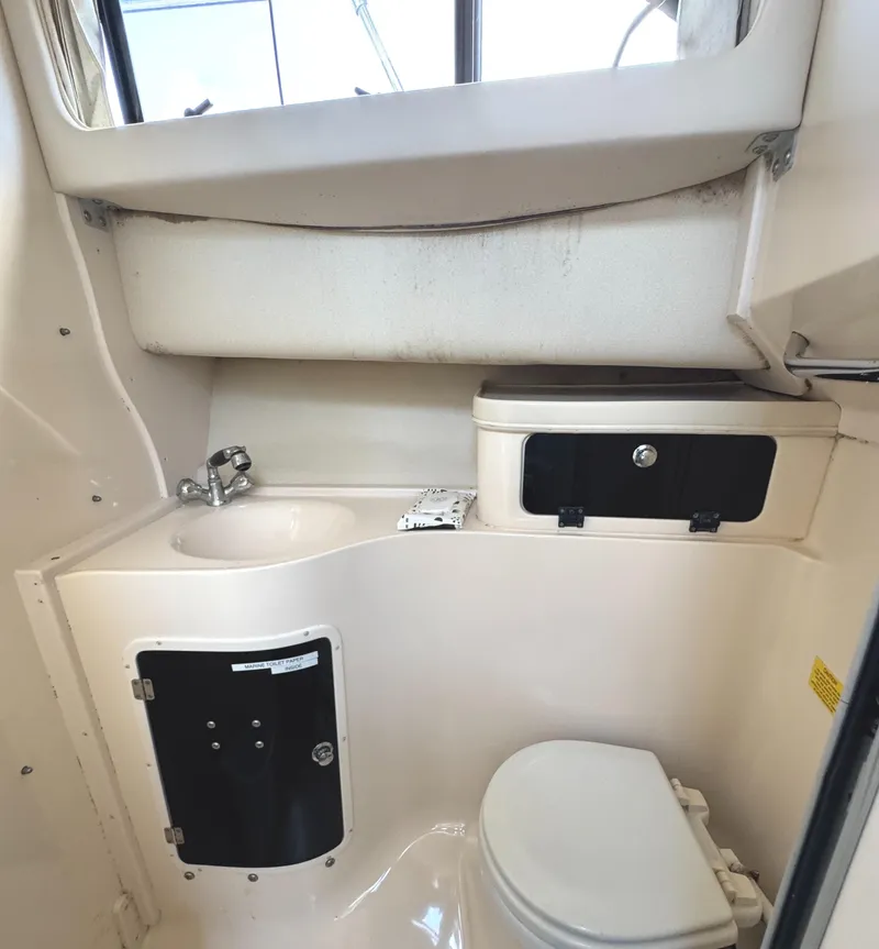 Slide: The Image of 2003 Grady-White Marlin 300 boat bathroom with sink, toilet, and storage compartments. - 28