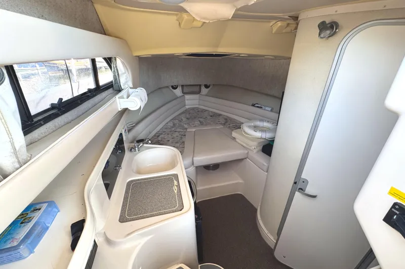 Slide: The Image of 2003 Grady-White Marlin 300 cabin interior with sink, bed, and storage. - 29