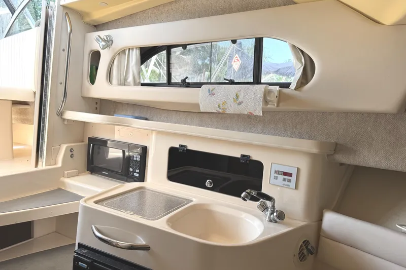 Slide: The Image of 2003 Grady-White Marlin 300 boat interior with kitchenette, sink, and microwave. - 31