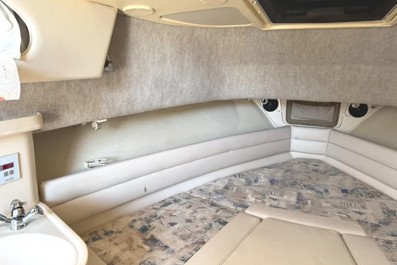 Slide: The Image of 2003 Grady-White Marlin 300 cabin interior with beige upholstery and compact sink. - 32