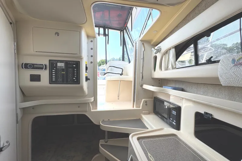 Slide: The Image of 2003 Grady-White Marlin 300 cabin interior with control panel and microwave. - 34