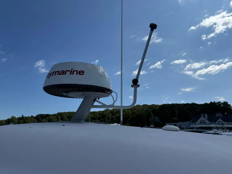 Slide: The Image of Radar equipment on a 2003 Grady-White Marlin 300 boat under a clear blue sky. - 36