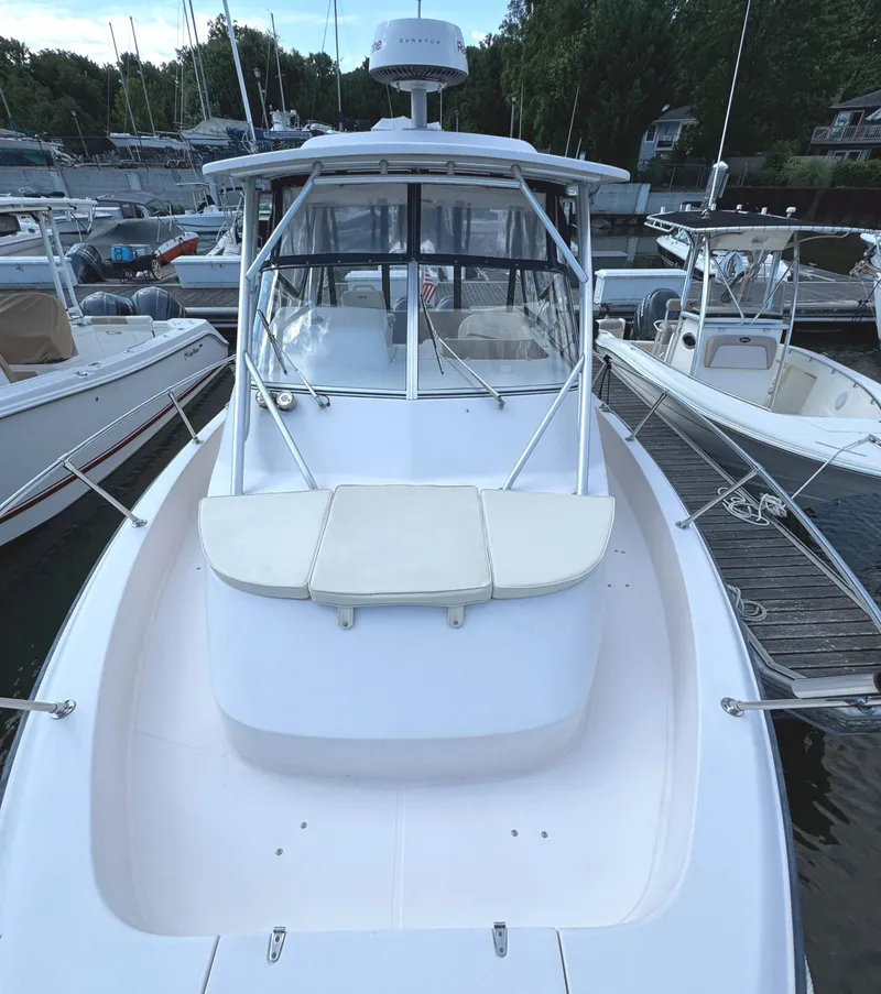 Slide: The Image of 2003 Grady-White Marlin 300 boat docked at marina, front view. - 37
