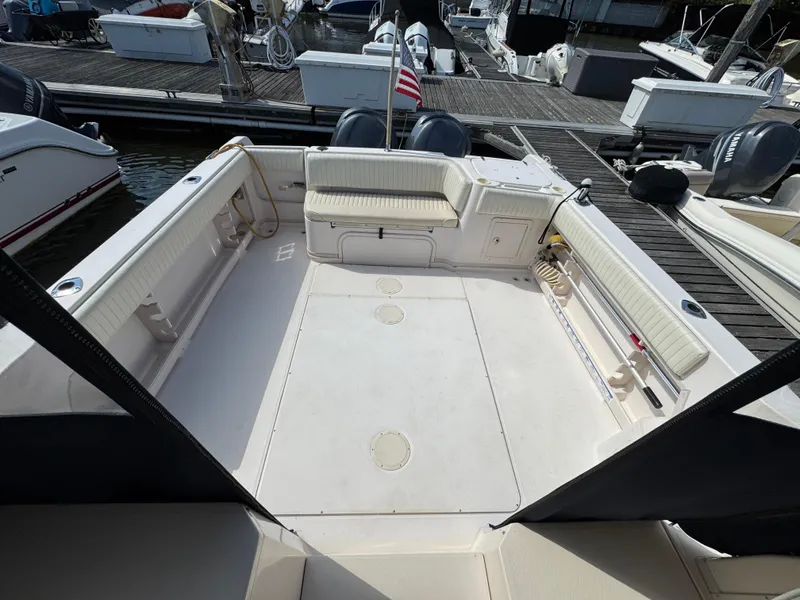 Slide: The Image of 2003 Grady-White Marlin 300 boat interior with spacious deck and seating at marina. - 5