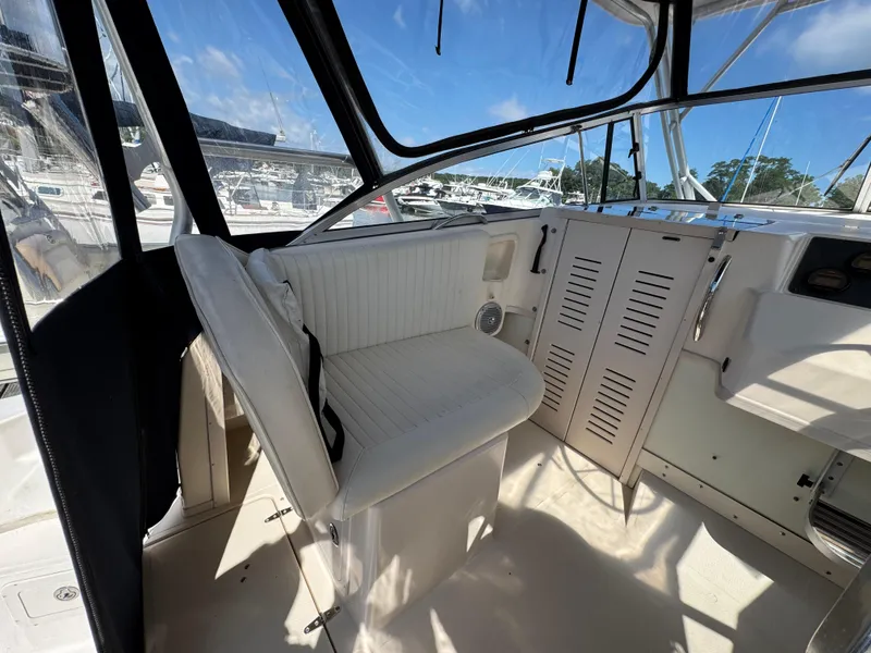 Slide: The Image of 2003 Grady-White Marlin 300 boat interior with white seating and clear windows. - 6