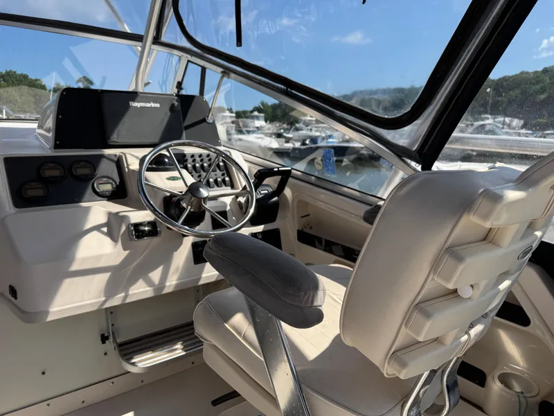 Slide: The Image of 2003 Grady-White Marlin 300 boat cockpit with steering wheel and controls. - 7