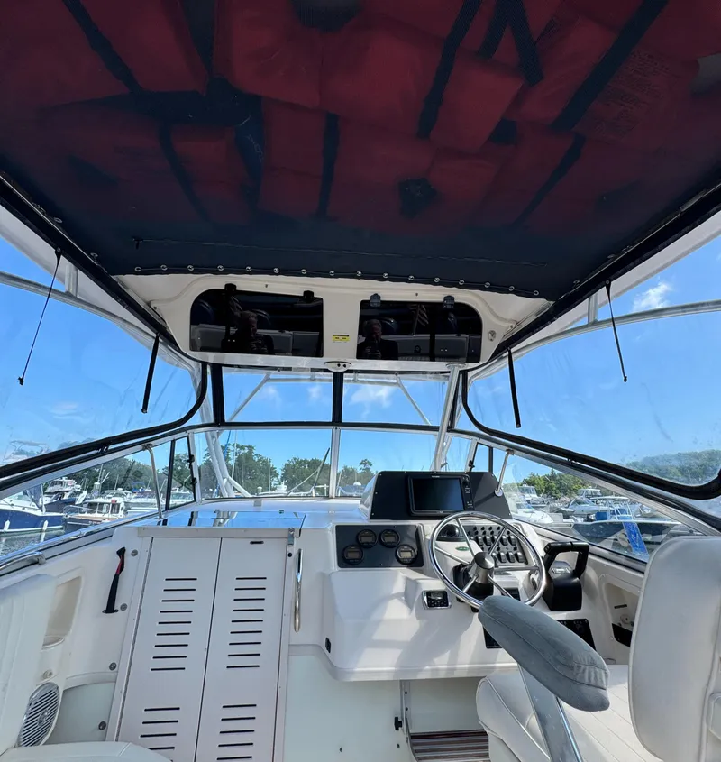 Slide: The Image of 2003 Grady-White Marlin 300 boat interior with helm, steering wheel, and navigation equipment. - 9